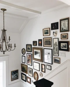 A wall with hanging frames styled on the wall