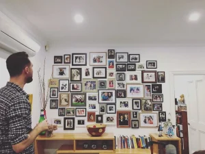 Lots of frames hanging on the wall