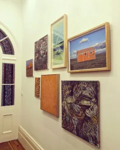 A wall with picture frames hanging