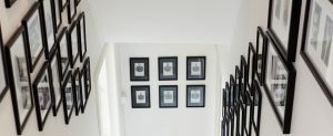 Frames hanging on the wall down the stairs